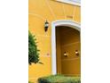 Condo entrance featuring a bright, painted exterior and decorative wall lighting at 3368 Robert Trent Jones Dr # 40808, Orlando, FL 32835