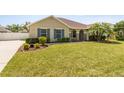 Beautiful home featuring a well-kept lawn, landscaped garden beds, and blue window shutters at 350 Black Springs Ln, Winter Garden, FL 34787