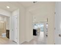 Bright entryway showcasing tile flooring, with a view of the living area and bathroom at 3729 Pacific Ln, Davenport, FL 33897