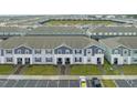 Expansive aerial view of a community of townhomes with parking and green spaces at 3838 Lana Ave, Davenport, FL 33897
