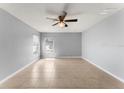 Large bedroom with a ceiling fan and lots of natural light from the two windows overlooking the front yard at 408 Magpie Ct, Kissimmee, FL 34759