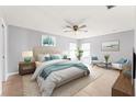 Nicely decorated main bedroom featuring a ceiling fan, two windows, and neutral paint to allow for lots of natural light at 408 Magpie Ct, Kissimmee, FL 34759