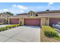 Attached two-car garage with ample driveway space, complemented by lush landscaping at 458 Ellis Square Ct, Sanford, FL 32771