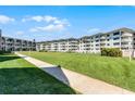 A well-maintained building and lawn offer a pleasant exterior view of the condos near the beach at 4821 Saxon Dr # 201B, New Smyrna Beach, FL 32169
