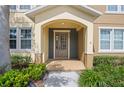 Close-up of home's entryway showing front door with sidelights and decorative archway at 5412 Factors Walk Dr, Sanford, FL 32771