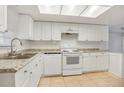 Functional kitchen featuring white appliances, stone countertops and ample cabinet space at 621 Ashberry Ln, Altamonte Springs, FL 32714