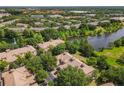 Aerial view of a residential community with a lake and lush greenery at 6240 Miramonte Dr # 102, Orlando, FL 32835