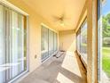 Screened in patio with ceiling fan and sliding glass doors at 6240 Miramonte Dr # 102, Orlando, FL 32835