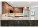 Bright, updated kitchen featuring wood cabinets, stainless steel appliances, and marble countertops at 690 Osceola Ave # 502, Winter Park, FL 32789