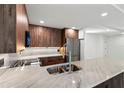 Open kitchen showcasing wood cabinets, marble counters and stainless steel appliances at 690 Osceola Ave # 502, Winter Park, FL 32789