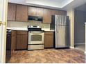 Functional kitchen featuring stainless steel appliances and ample cabinet space at 7089 Balboa Dr # 7089, Orlando, FL 32818