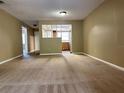 Spacious living room with neutral carpeting and a view into the kitchen at 7089 Balboa Dr # 7089, Orlando, FL 32818