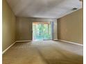 Bright living room featuring a sliding glass door to a screened lanai at 7089 Balboa Dr # 7089, Orlando, FL 32818