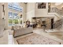Elegant foyer boasts soaring ceilings, a grand staircase with iron railings, and marble flooring at 8590 Apache Trl, Kissimmee, FL 34747