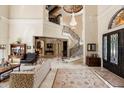 Spacious foyer features a grand staircase with iron railings, marble floors, and high ceilings with ornate details at 8590 Apache Trl, Kissimmee, FL 34747