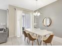Dining room with tile floors, modern lighting, and sliding door access at 8969 Stinger Dr, Davenport, FL 33896
