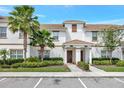 Townhouse exterior featuring well-maintained landscaping and a welcoming entrance at 8969 Stinger Dr, Davenport, FL 33896