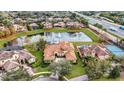 Expansive aerial view showcases estate home near the community lake, tennis courts, pool, lush landscaping, and nearby highway at 9178 Panzani Pl, Windermere, FL 34786