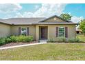 Welcoming front exterior with manicured landscaping and a cozy entryway at 936 Dandridge Dr, Deltona, FL 32725
