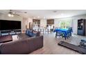 Open floor plan with living, dining, and kitchen area with stainless steel appliances at 936 Dandridge Dr, Deltona, FL 32725