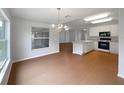 Bright kitchen with stainless appliances, modern island, and cozy dining area bathed in natural light at 9665 Se 125Th Ln, Summerfield, FL 34491