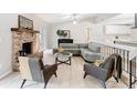 Bright living room featuring light wood floors, brick fireplace, and stylish furniture at 1025 Winter Springs Blvd, Winter Springs, FL 32708