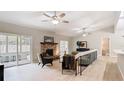 Spacious living room featuring light wood floors, brick fireplace, ceiling fans, and natural light at 1025 Winter Springs Blvd, Winter Springs, FL 32708