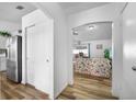 Bright hallway with wood floors leading to the living room and stainless steel appliances at 1065 Jason Ridge Ct, Kissimmee, FL 34747