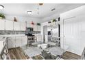 Eat-in kitchen featuring stainless steel appliances, white cabinets, and glass-top dining table at 1065 Jason Ridge Ct, Kissimmee, FL 34747