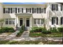 Well-maintained two-story townhome with black shutters, clean landscaping and an inviting entrance at 1068 Lake Baldwin Ln, Orlando, FL 32814