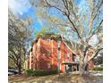 Exterior of a three-story building showcases brick and well-maintained landscaping with parking lot and trees at 107 Vista Verdi Cir # 237, Lake Mary, FL 32746