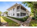 Two-story condo building featuring charming balconies and well-maintained landscaping at 1140 S Orlando Ave # E-1, Maitland, FL 32751