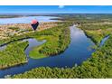 Scenic aerial view of the community, showcasing lush greenery, lakes, and winding waterways at 132 Rosa Bella Vw, Debary, FL 32713