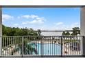 Relaxing balcony view overlooking the pool and the serene water at 13415 Blue Heron Beach Dr # 208, Orlando, FL 32821