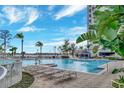 A luxurious pool area with lounge chairs and a cabana at 13415 Blue Heron Beach Dr # 208, Orlando, FL 32821