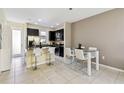 Eat-in kitchen features stainless steel appliances and a dining area with seating at 14090 Avenue Of The Groves, Winter Garden, FL 34787