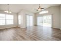 Bright living room with hardwood floors, vaulted ceiling, and large sliding glass doors at 1413 Timberbend Cir, Orlando, FL 32824