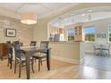 Traditional dining area connected to kitchen with wood floors and neutral paint at 1425 Chatfield Pl, Orlando, FL 32814