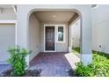 Welcoming front porch with brick pavers, offers an inviting entry to the home at 14613 Erice Ave, Clermont, FL 34714