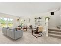 Open-concept living room with lots of natural light, soft carpet and stylish decor at 1559 Scrub Jay Ct, Deland, FL 32724