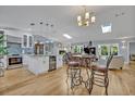 Bright, open-concept living space with hardwood floors and a modern kitchen with granite countertops at 1621 Highland Dr, Longwood, FL 32750