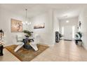Bright dining area with modern chandelier, sleek white chairs and view to foyer at 1645 Denali St, Davenport, FL 33837