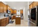 Well-equipped kitchen with stainless steel appliances, center island, and plenty of counter space at 1645 Denali St, Davenport, FL 33837