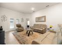 Comfortable living room featuring plush furniture, neutral paint, and a sliding glass door allowing ample natural light at 1645 Denali St, Davenport, FL 33837