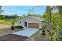 Charming single-Gathering home featuring a well-manicured lawn and a two-car garage at 170 Blaine St, Eustis, FL 32726