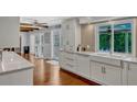 Bright kitchen with white cabinets, double sink, and hardwood floors at 1710 Alvarado Ct, Longwood, FL 32779