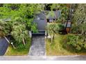 Birds eye view of a well maintained townhome featuring a driveway and mature palm trees at 207 Sweet Gum Way, Longwood, FL 32779