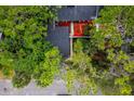 Home with unique landscaping featuring bright red mulch and mature trees at 207 Sweet Gum Way, Longwood, FL 32779
