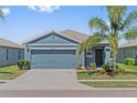 Charming single-story home with a well-maintained lawn, mature landscaping, and an attached two-car garage at 2907 Sime St, New Smyrna Beach, FL 32168
