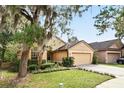Beautiful single-story home boasting a well-landscaped front yard and a two-car garage at 2987 Sabel Oak Pl, Oviedo, FL 32765